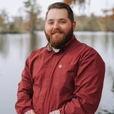 Jonathan Qualls, MBA, co-owner of S&S HVAC, by the water in Lake Charles