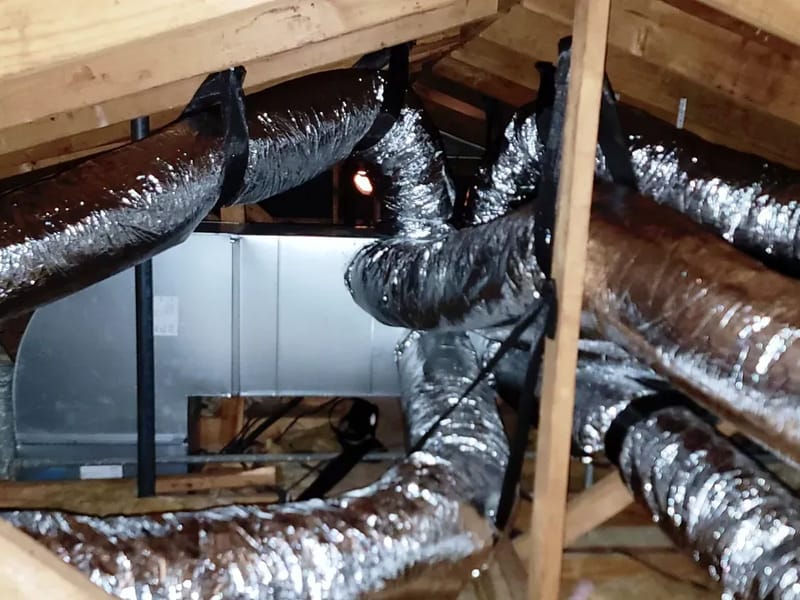 New insulated flex ductwork run from an air handler across an attic